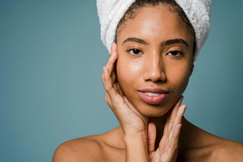 a young woman who has a towel on her head