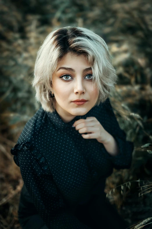 young blond woman with short hair posing for a picture