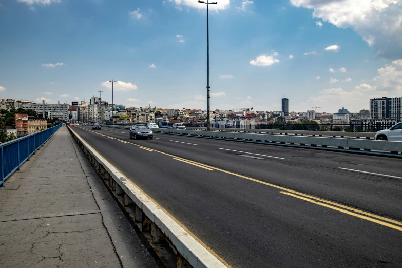 cars traveling down a road in a city