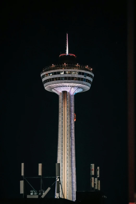 a tall tower with some lights on it at night