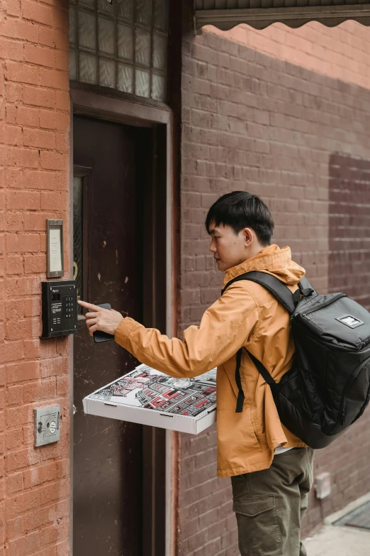 a  with a bag entering a door