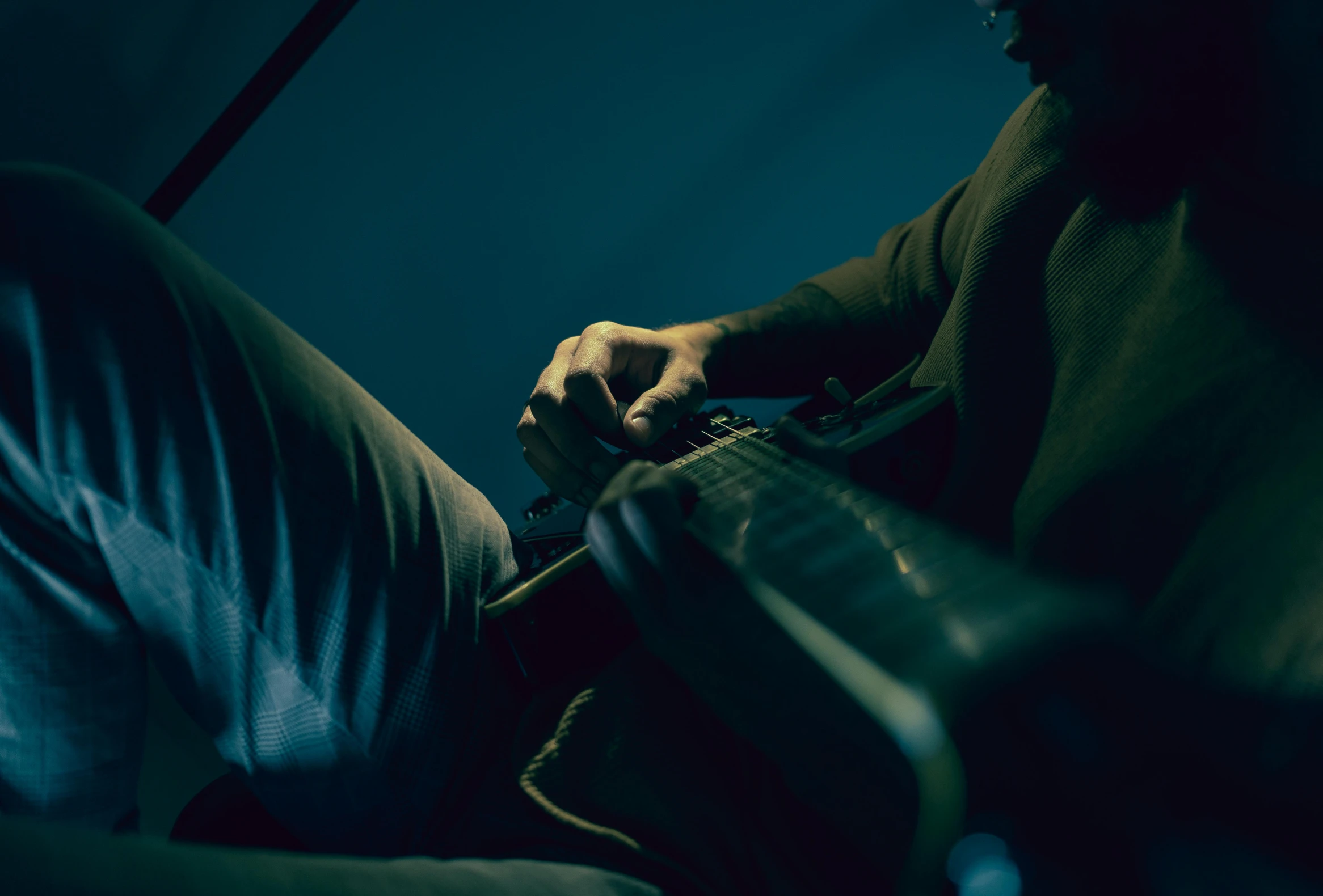 a man sitting in a chair holding a guitar