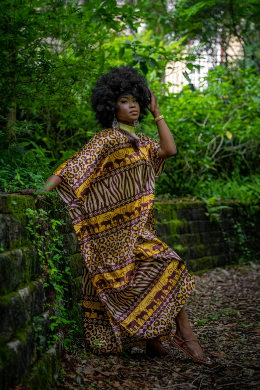 a woman standing on the path in a patterned dress