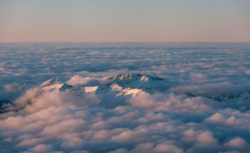 view of the snow covered mountains from the air