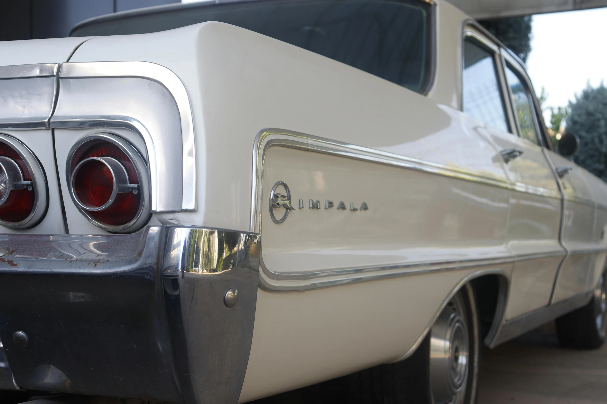 the tail lights and emblem on a white car