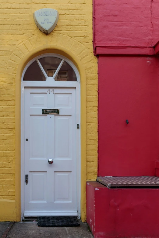 a yellow and red door in an empty building