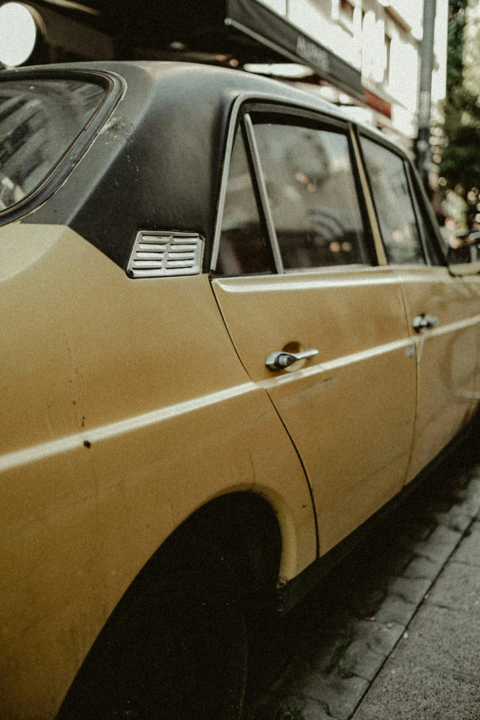 yellow car parked on the side of the street