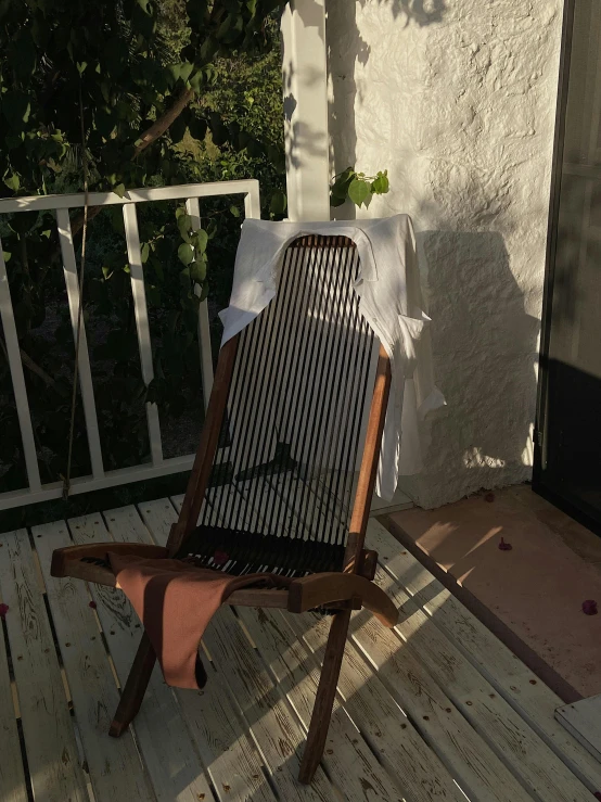 the chair is sitting on the porch by the stairs