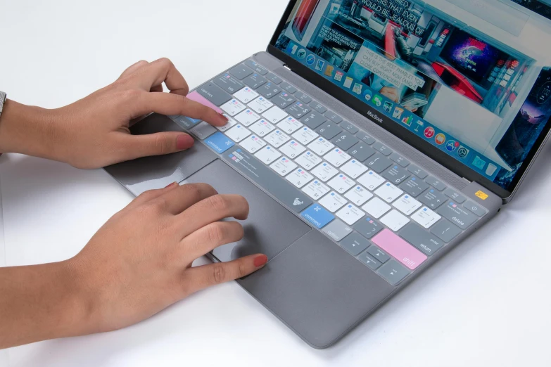 someone using their macbook air keyboard on a table