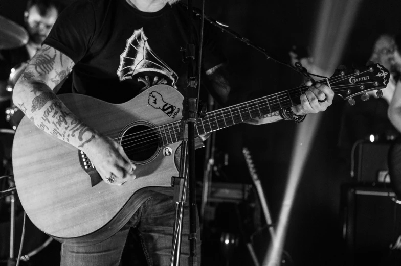 a black and white po of a man playing guitar