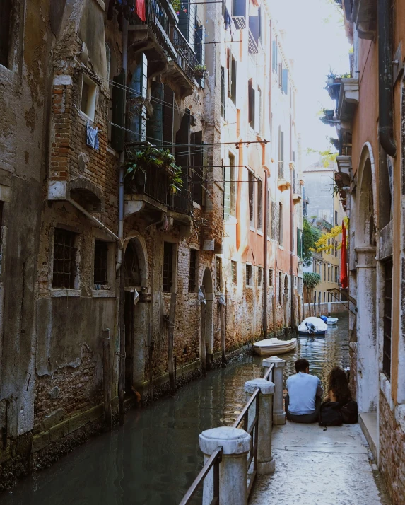 a narrow waterway between old buildings and some water