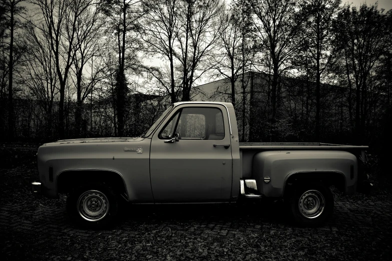 the classic truck is parked outside in the dark