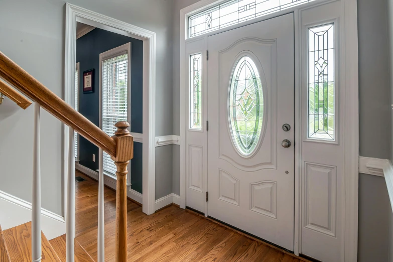 an entryway with hardwood floor and gray walls