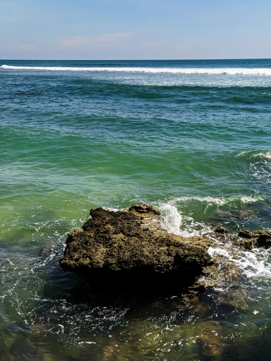 a view of the ocean from a rocky shore