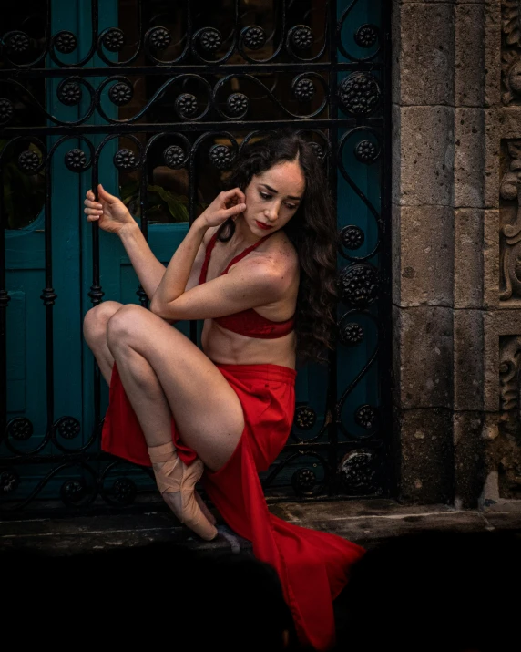 a woman in red dress sitting on stairs