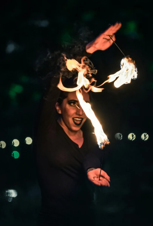 a man is juggling fire torches in the night sky