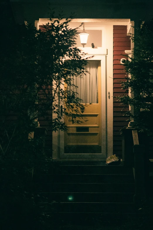 the front door of a house is illuminated