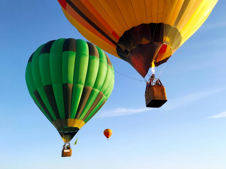 three large colorful  air balloons against a blue sky