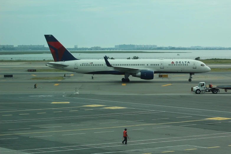 an airplane sitting on the runway as passengers board it