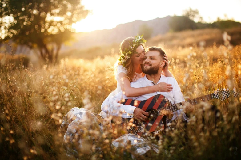 a beautiful woman hugging a man in a field