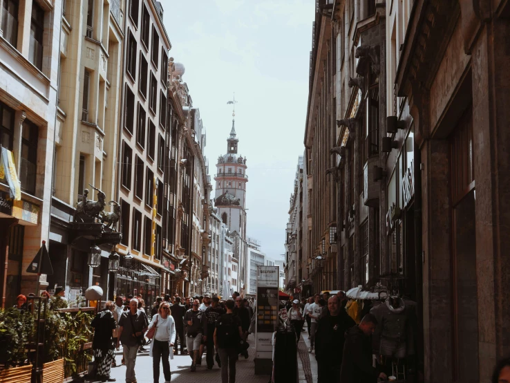 a crowd of people that are walking down the street