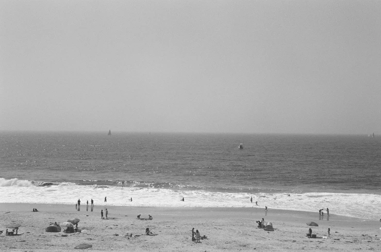 a black and white po of a beach with lots of people