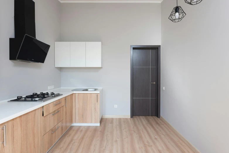 a small kitchen with wooden floors and counter tops