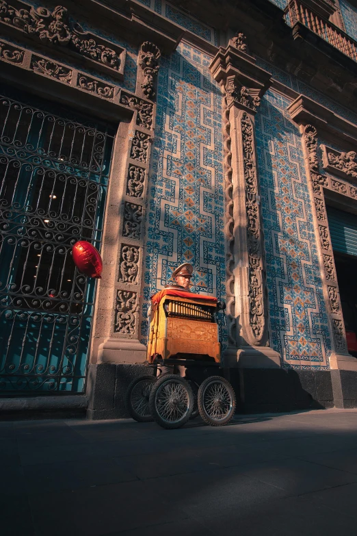 a big orange cart is sitting on the street