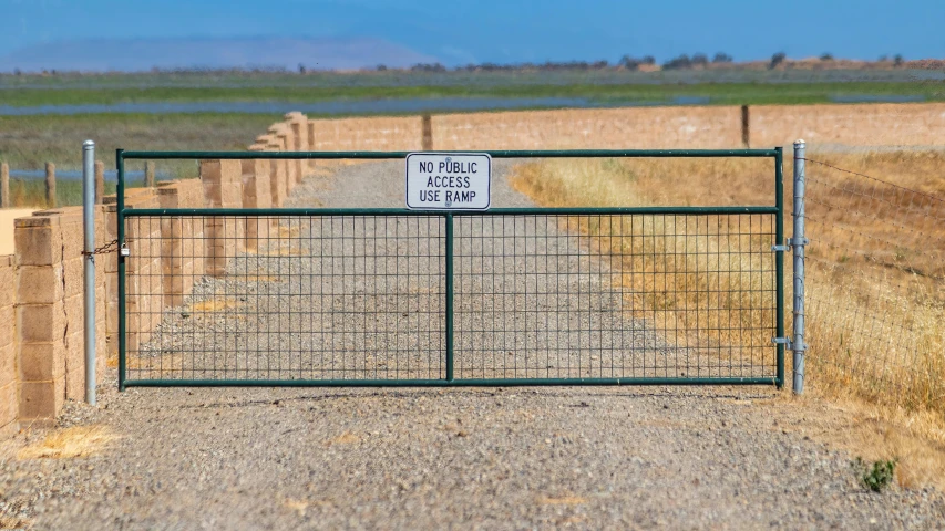 a road and gate on a dirt road