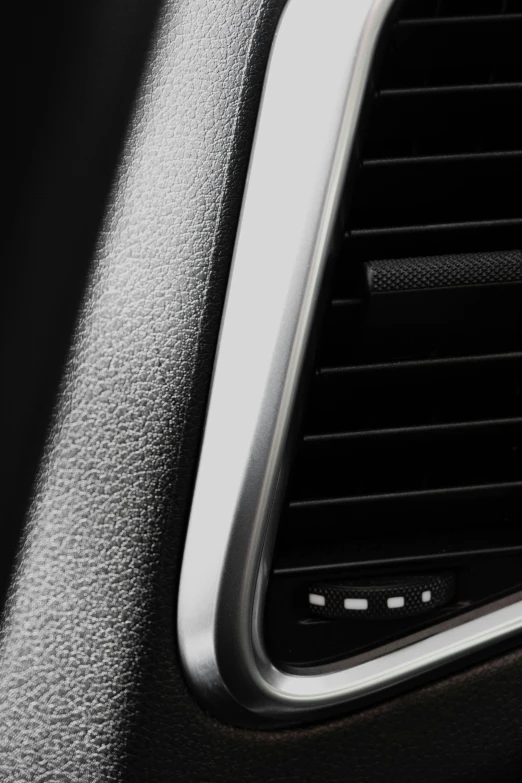 an air vent in a vehicle next to a white on