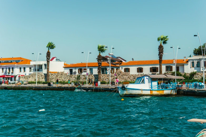 an image of houses on the coast near a river