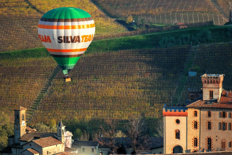 a  air balloon is being flown above some buildings