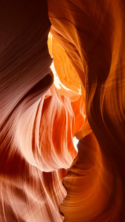 a view of a very wide narrow canyon with tall cliffs and very light in the distance