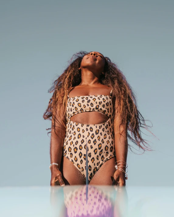 a large woman is wearing an animal print bathing suit