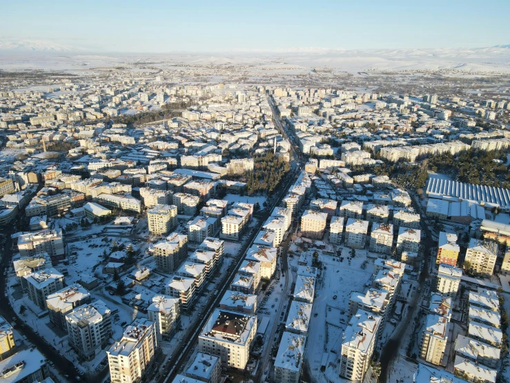 a snowy city with lots of tall buildings