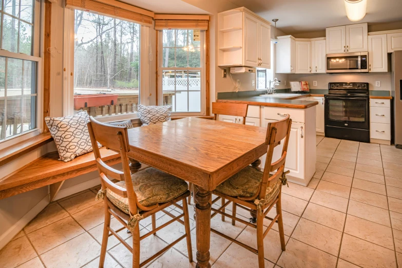 an open kitchen with a dining table and chairs