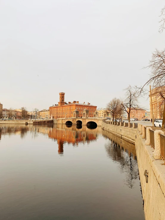 the small canal is empty and the bridge is in disrepair