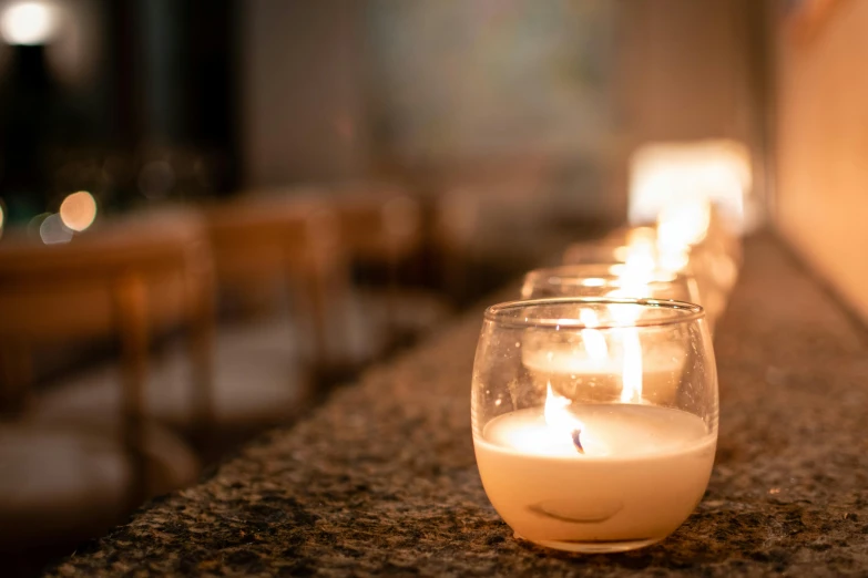 three lit candles sitting on top of a counter