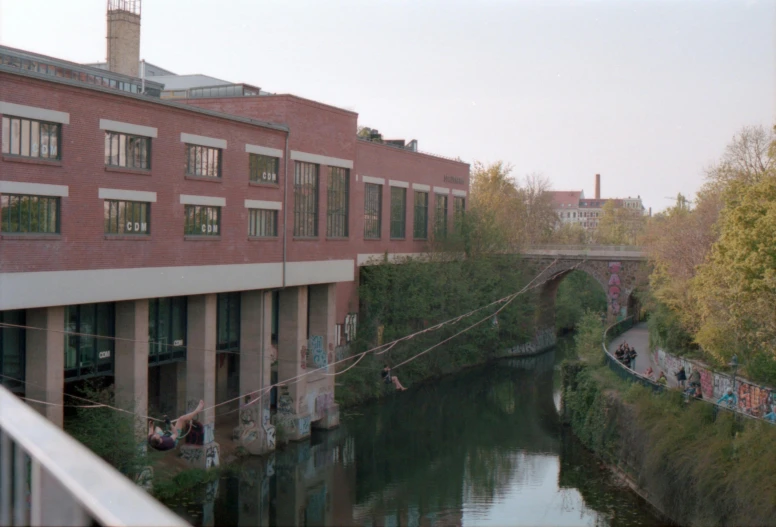 a bridge over water in front of a building and a river