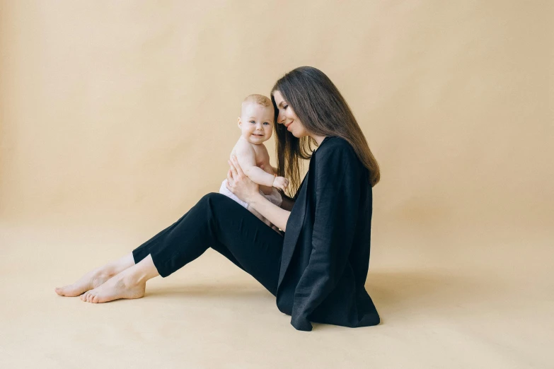 a woman and her baby are sitting together