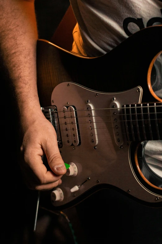 a person holding a guitar string with their left hand