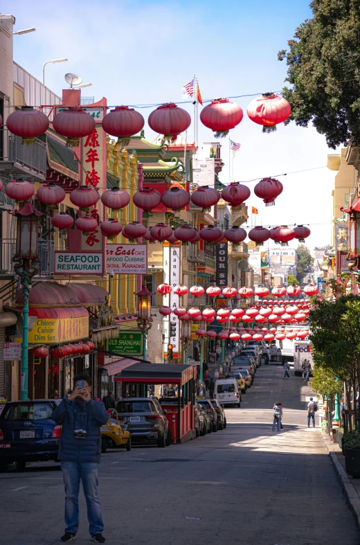 a street lined with chinese lanterns during the day