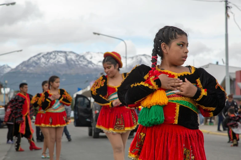 several people are in parade wear, some of which are holding instruments