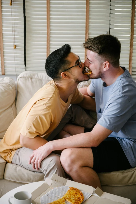 a couple of men sitting on top of a couch