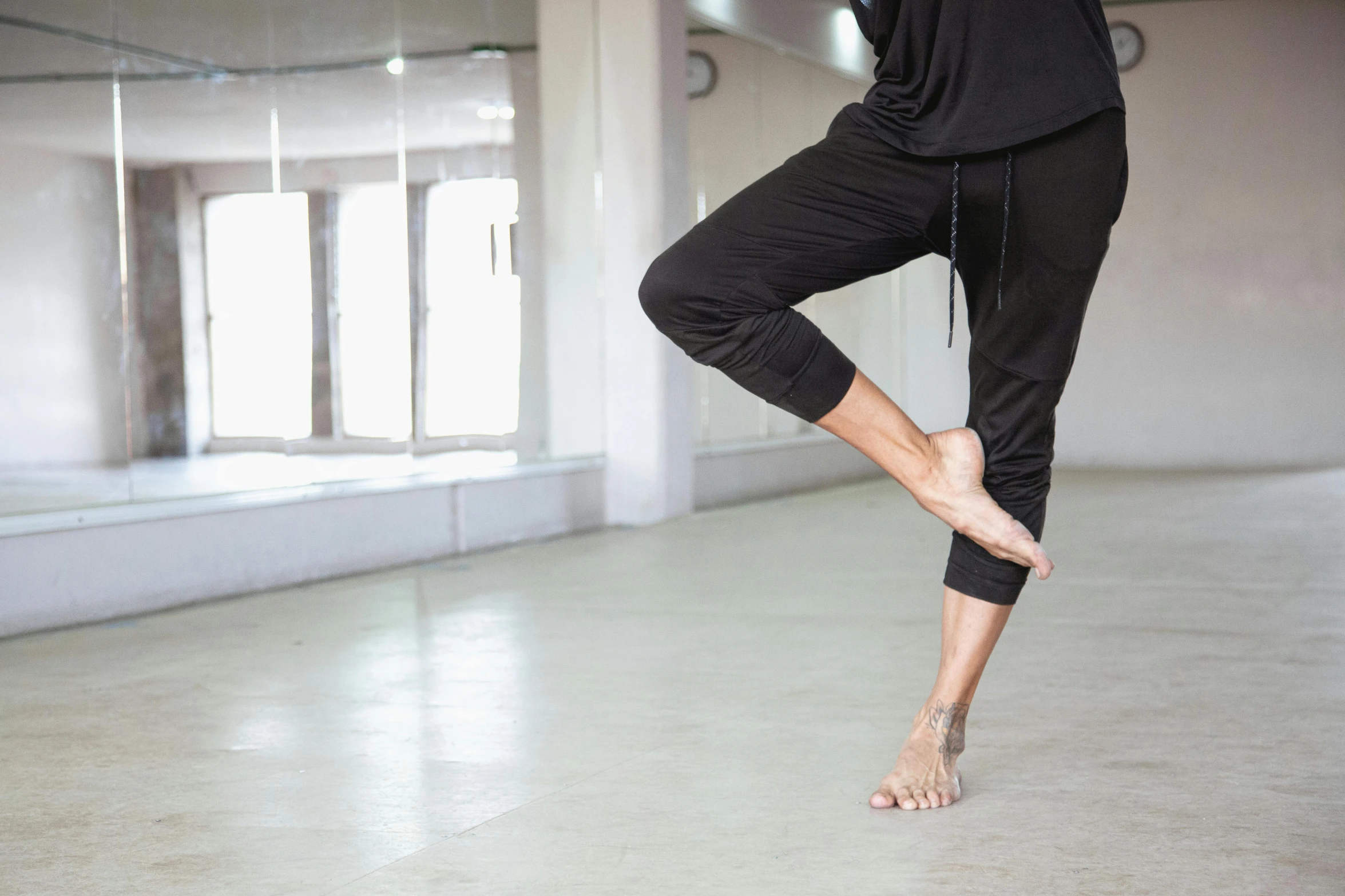 woman stretching with her feet up in a large room