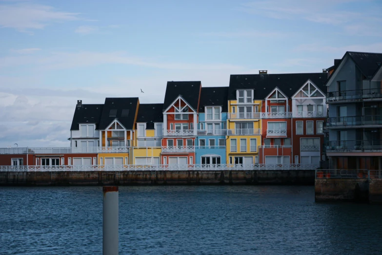 a row of buildings with colorful paint along the water