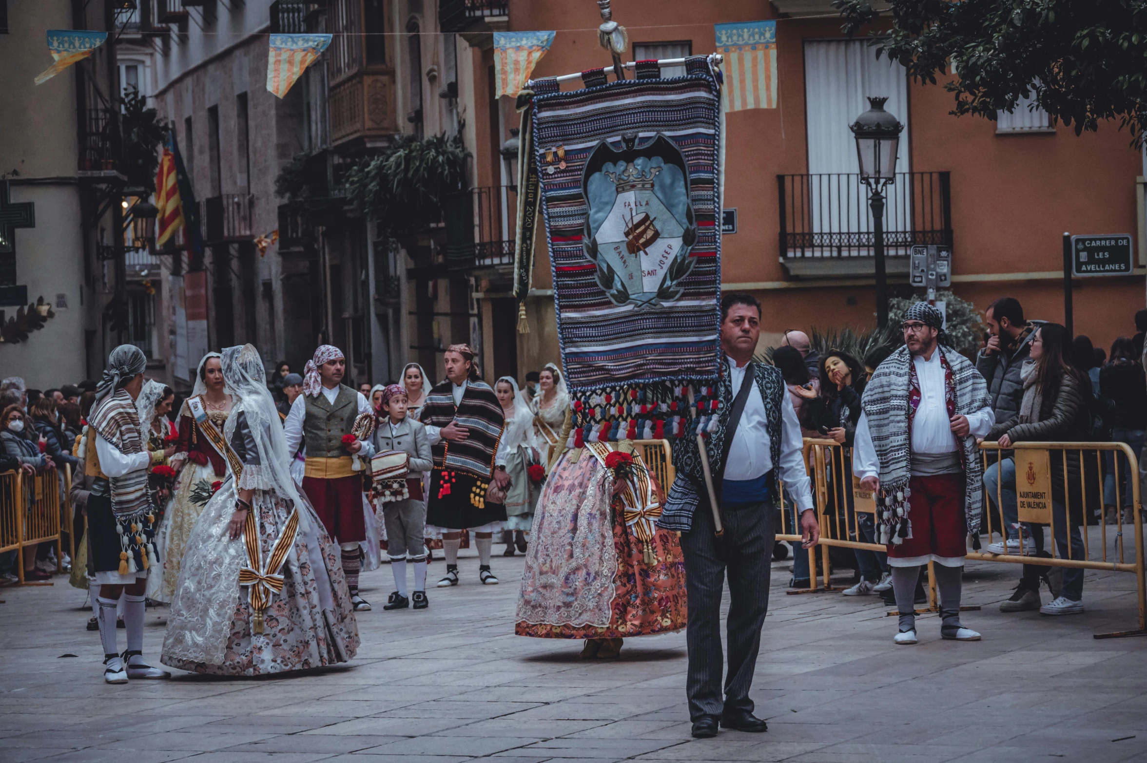 several people in elaborate clothing perform on the street