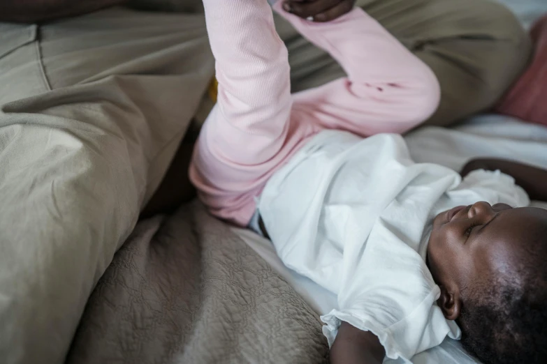 a young baby playing with a cell phone on a couch