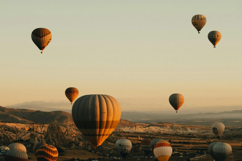 group of balloons flying above an open field