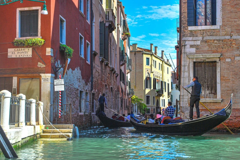 a canal with buildings and gondola for people to row